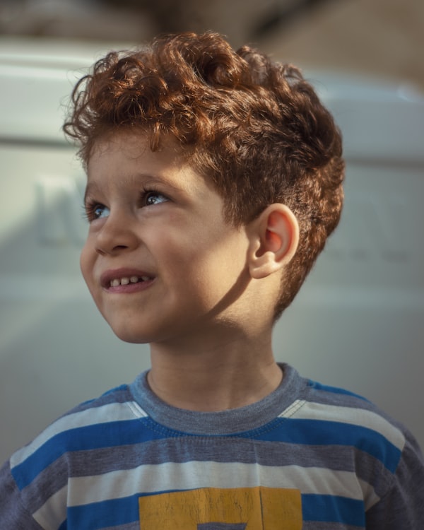 Young person smiling in a garden